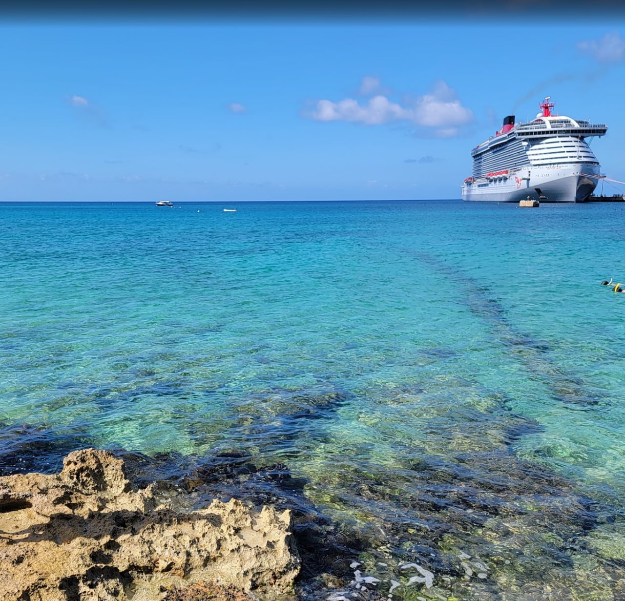 Virgin Voyages ship off the coast during our Lock It In Caribbean sailing